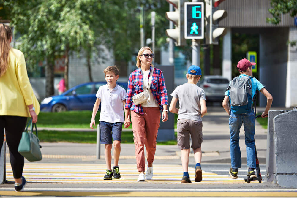 Pedestrian crossing as walk sign turns green.