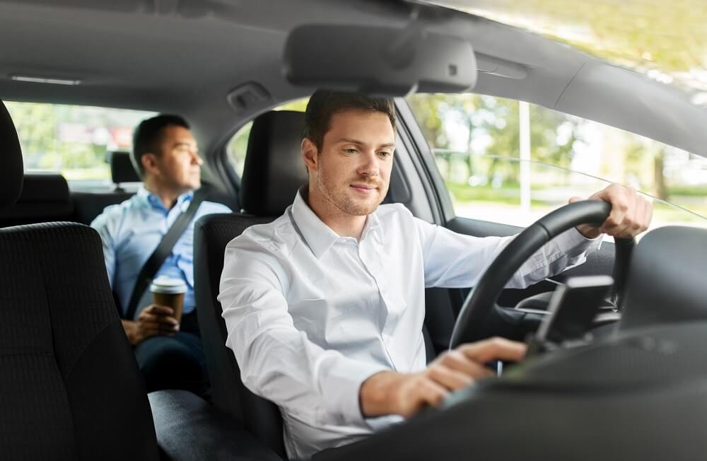 Uber or Lyft driver picking up passenger.