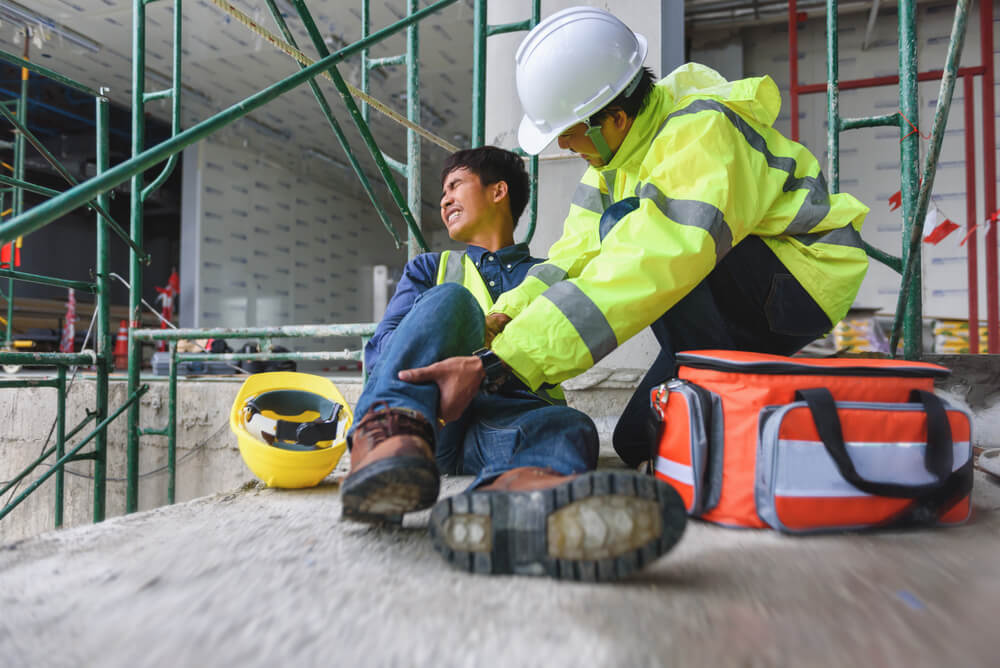 Construction worker suffering injury at site.