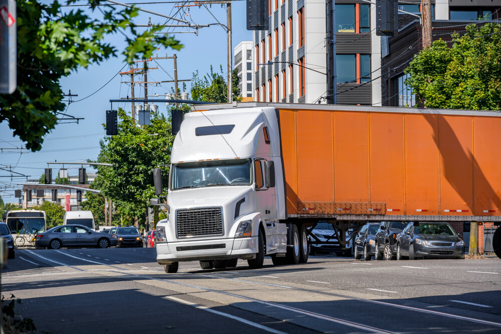 Orange truck making a left turn.