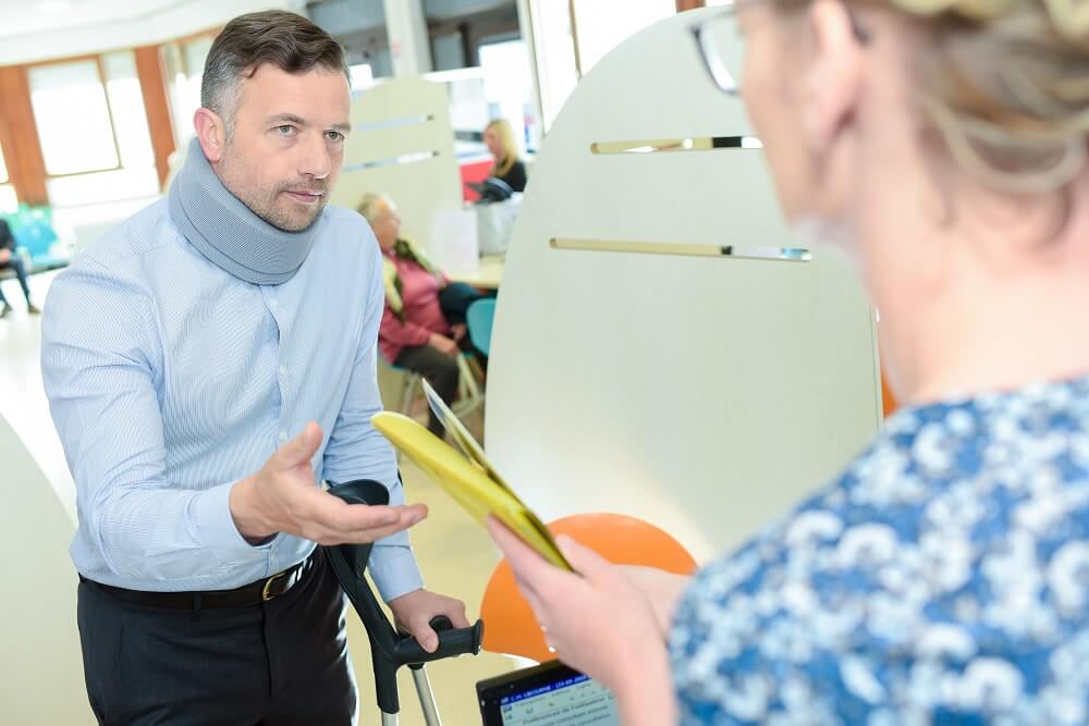 Injured worker passing his workers compensation claim in the office.