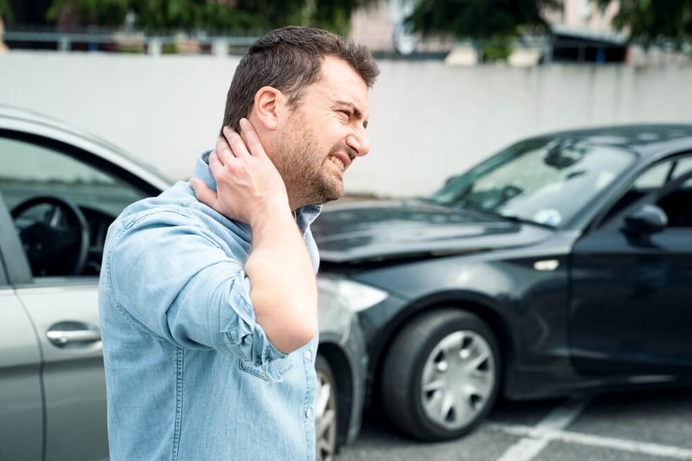 Driver suffering whiplash from car accident.