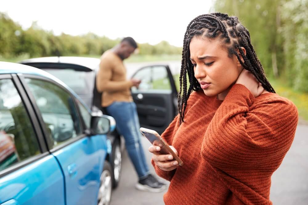 Lady driver suffering whiplash from accident.