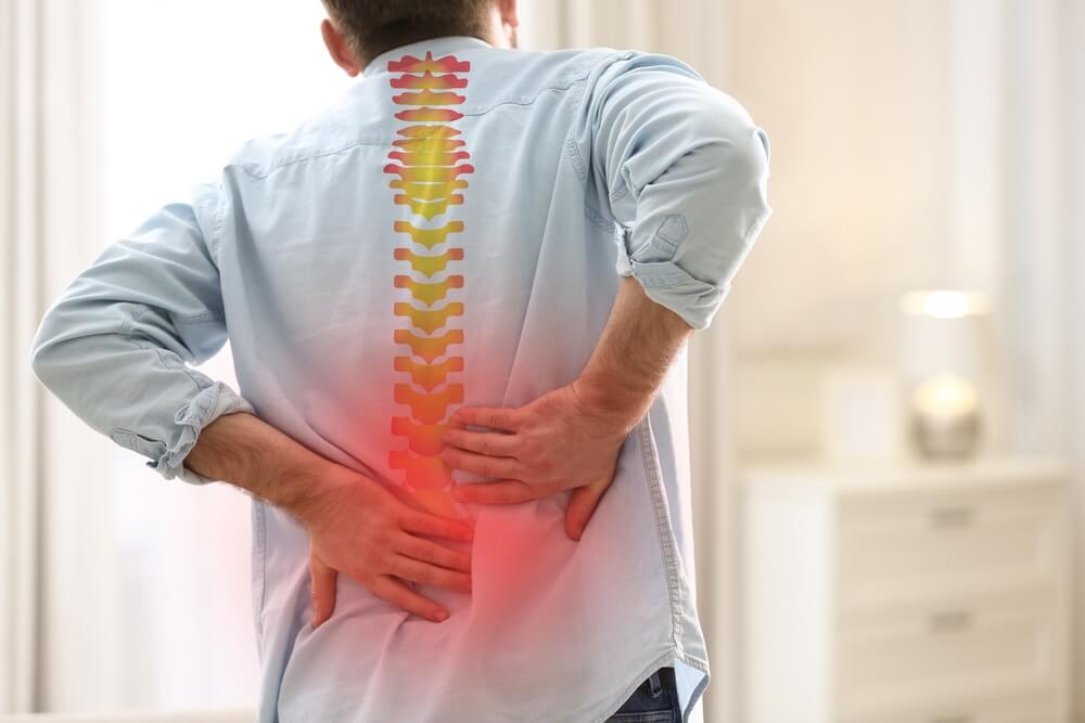Man suffering pain from spinal injuries.