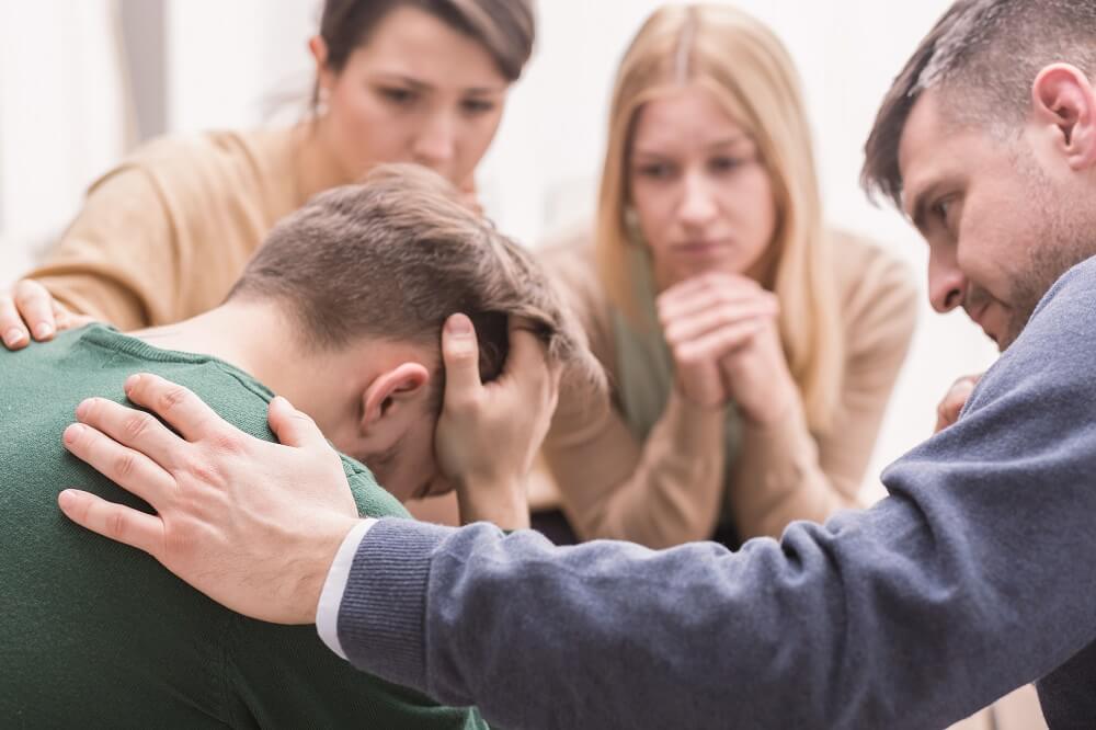 Emotionally distressed man in counseling session.
