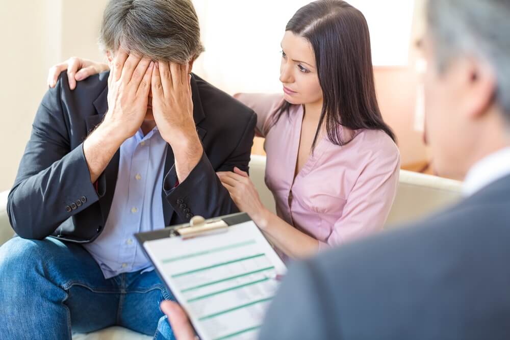Grieving family discussing a wrongful death claim with a lawyer.
