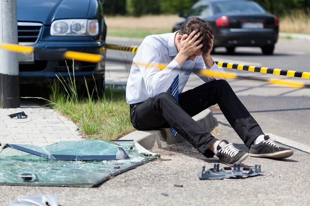 Worried driver calling insurance to report accident.