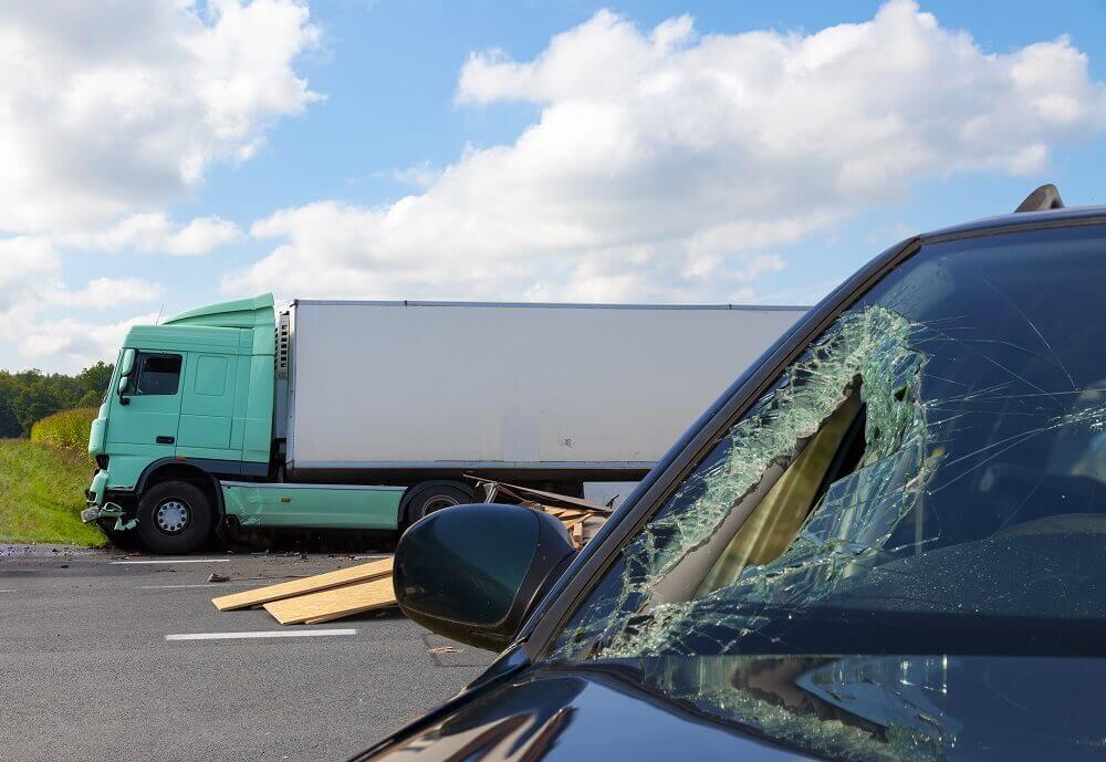 Car and truck accident in the road.